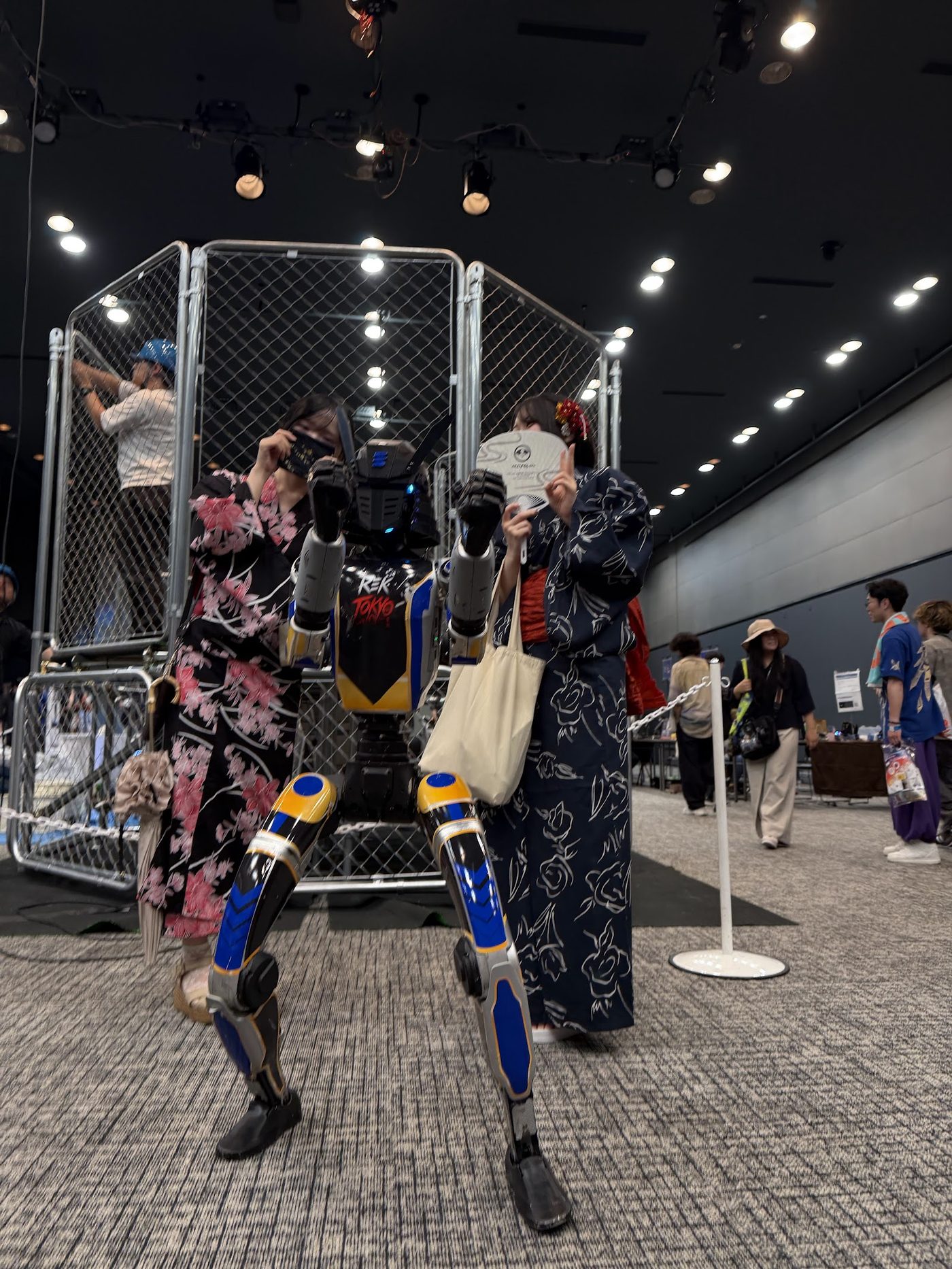 REK TOKYO 2026：ケージ前でREK機体と記念撮影する浴衣の来場者